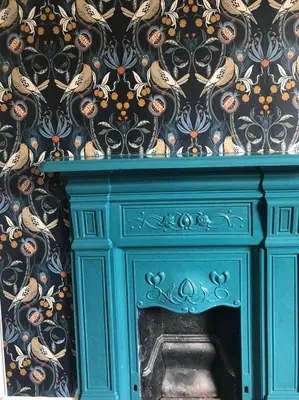 a turquoise fireplace with a floral wallpaper at Llangollen Townhouse 4 bedroom in Llangollen