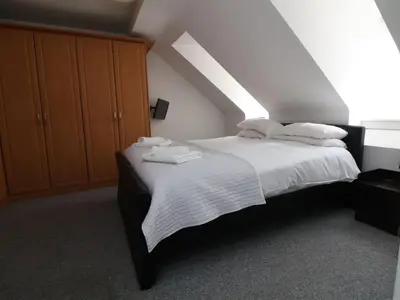 a bedroom with a bed with towels on it at Llangollen in Llangollen