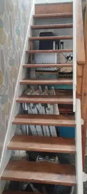 a set of wooden stairs leading up to the top at 2-Bedroom cottage in Barmouth old town with sea views in Barmouth