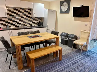 a kitchen and dining room with a table and chairs at Marine Apartment in Aberystwyth