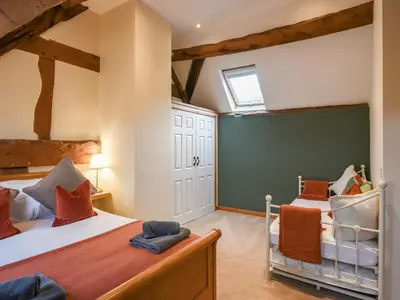 a bedroom with two beds and a window at Uk46589 - Kibble in Church Stretton