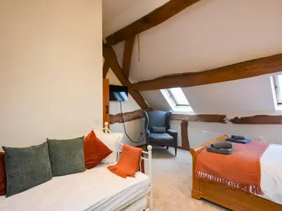 a bedroom with a bed and a chair at Uk46589 - Kibble in Church Stretton