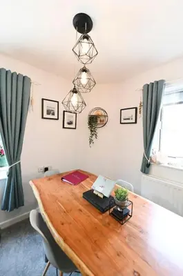 a dining room with a wooden table with chairs at Relaxing Aberdovey Retreat, close to beach in Aberdyfi
