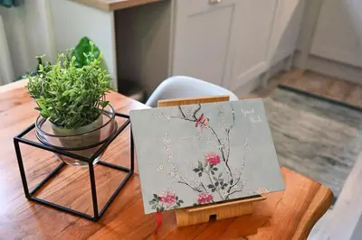a table with a painting and a plant on it at Relaxing Aberdovey Retreat, close to beach in Aberdyfi