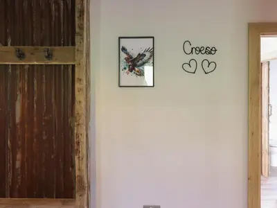 a room with a door and a clock on the wall at Bwncath in Welshpool