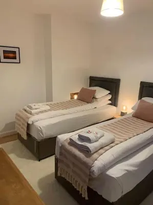 a bedroom with two beds with towels on them at Mountain views in the heart of Brecon Town in Brecon