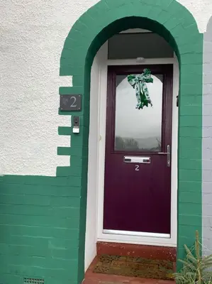 a purple door with an archway in front of a building at Mountain views in the heart of Brecon Town in Brecon