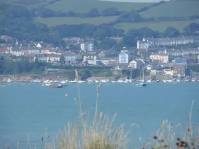 a large body of water with a city in the background at Quirky Cottage with Private Garden Nr New Quay Cardigan Bay in Llandysul