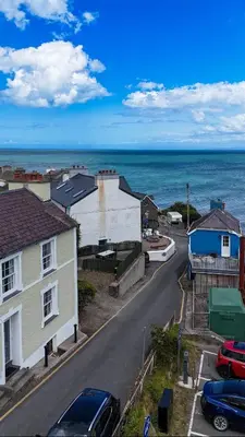a view of a street with houses and the ocean at 3 Prospect Place, New Quay, sleeps 6, parking, sea views, dog friendly in New Quay