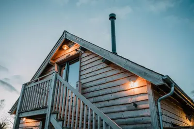 a cabin with lights on the side of it at Hafan in Glasbury