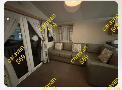 a living room with a couch and a window at Sean's 569 cader court 045 in Talybont