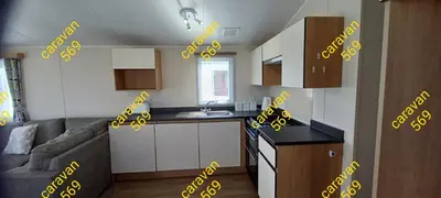 a kitchen with yellow writing on the walls of a apartment at Sean's 569 cader court 045 in Talybont