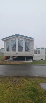 a house that is sitting on the side of a road at Caravan 73 snowdon summit 013 in Talybont