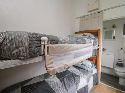 two bunk beds in a room with a toilet at Chalet 32 in Aberystwyth