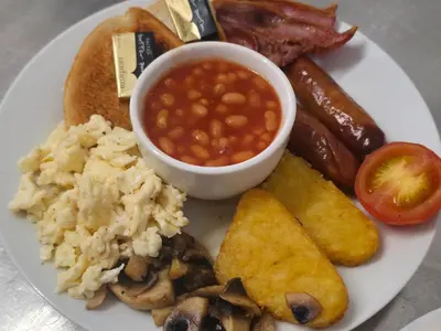 a plate of breakfast food with beans and other foods at The Springfield Hotel in Fairbourne