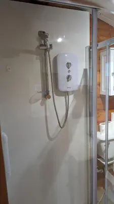 a shower in a bathroom with a shower at Snowdonia Log Cabin 2 in Trawsfynydd