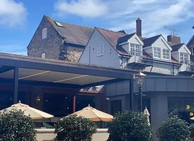 a building with umbrellas in front of a building at Apartment Sleeps 2 with Wi-Fi in Ludlow