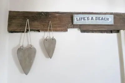 a couple of hearts hanging on a wall at Hen Blas, 14th century 2 bedroom Cottage in Barmouth
