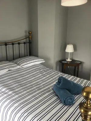 a blue towel sitting on top of a bed at Harbour House in Barmouth