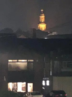 a clock tower on top of a building at night at Simply Shrewsbury, by Severn Theatre & Quarry Park in Shrewsbury