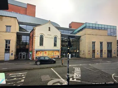 a car parked on a street in front of a building at Simply Shrewsbury, by Severn Theatre & Quarry Park in Shrewsbury
