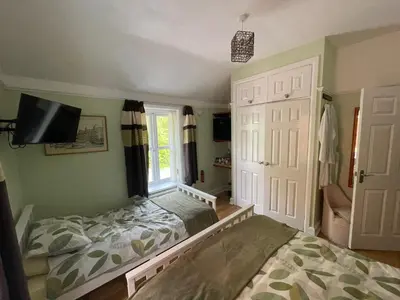 a bedroom with a bed and a window at Twyford Homestay B&B in Llandrindod Wells