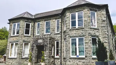 an old stone house with white windows at Amazing Cader views Torrent en suite in Dolgellau