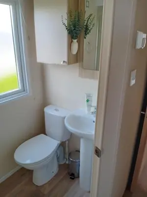 a bathroom with a toilet and a sink at 2 Bed Chalet - Sleeps 4 - Pets - Parking in New Quay