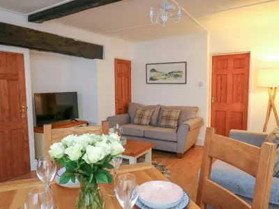 a living room with a couch and a table at 1 Penporth in Rhayader