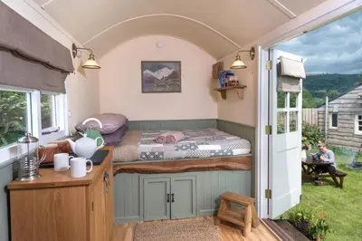 a small bedroom with a bed in a caravan at 1 Bed in Talybont-on-Usk oc-a29348 in Talybont