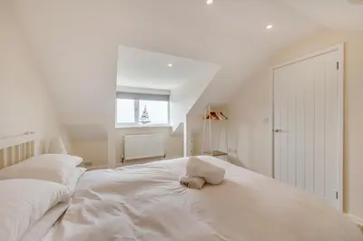 a white bed in a room with a window at 3 Bed in Aberdovey oc-v29263 in Aberdyfi