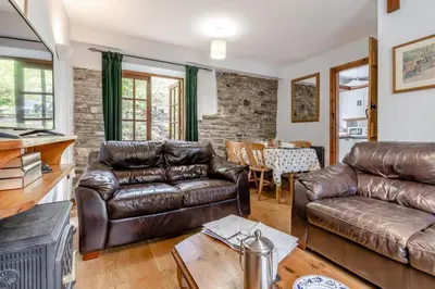 a living room with a leather couch and a table at 3 Bed in Knighton oc-b29329 in Felindre