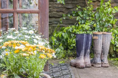 a group of rubber boots sitting next to a garden at 3 Bed in Knighton oc-b29329 in Felindre