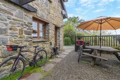 a bike parked next to a table and an umbrella at 2 Bed in Knighton oc-t29330 in Felindre