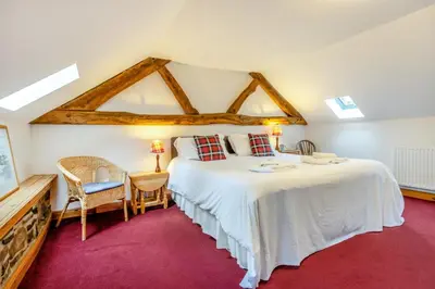 a bedroom with a large bed and a table and chairs at 2 Bed in Knighton oc-t29330 in Felindre
