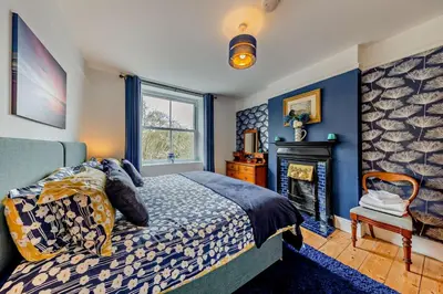 a bedroom with a bed and a fireplace at 5 Bed in Bontddu oc-c29184 in Penmaenpool