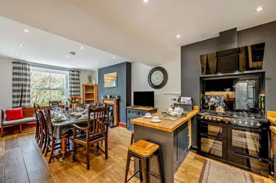 a kitchen and dining room with a table and a dining room at 5 Bed in Bontddu oc-c29184 in Penmaenpool