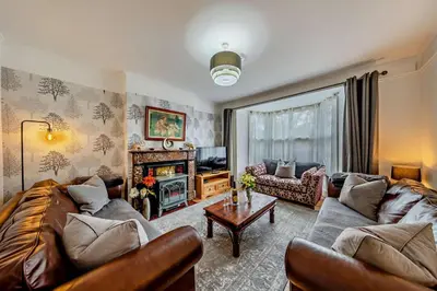 a living room with a couch and a tv at 5 Bed in Bontddu oc-c29184 in Penmaenpool