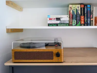 an old radio sitting on a shelf with books at 3 Bedroom home within walking distance of town - Pass the Keys in Shrewsbury