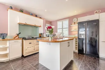 a kitchen with white cabinets and a black refrigerator at 3 Bed in Clyro oc-r29347 in Clyro