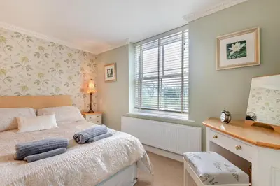 a bedroom with a bed and a desk and a window at 3 Bed in Clyro oc-r29347 in Clyro