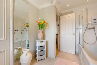 a bathroom with a vase of flowers on a table at 3 Bed in Clyro oc-r29347 in Clyro
