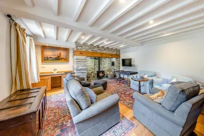 a living room with two couches and a fireplace at 4 Bed in Derwenlas oc-c29244 in Machynlleth