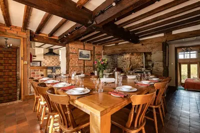 a large wooden table with chairs in a room at The Manor House in Church Stretton