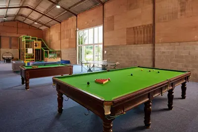 a large room with a pool table and a playground at Toad Hall in Church Stretton