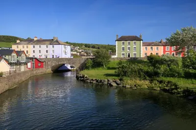 a bridge over a river in a town with buildings at Horseshoe Cottage Aberaeron in Ciliau-Aeron
