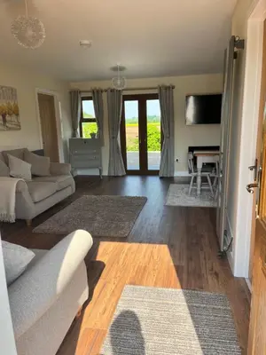 a living room with a couch and a table at Lilac Cottage in Stoke Prior