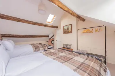 a bedroom with two beds in a attic at Mill Cottages Shrewsbury With Hottub in Merrington