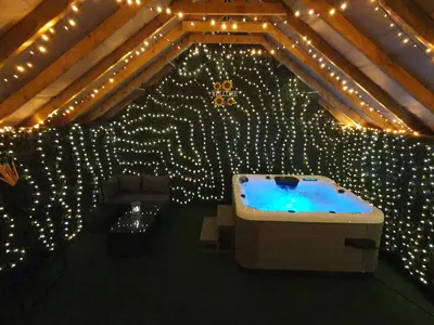 a room with a tub in a room with lights at Mill Cottages Shrewsbury With Hottub in Merrington