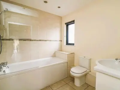 a bathroom with a tub and a toilet and a sink at Caban Dulas in Nantmel